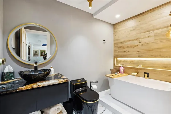 a bathroom with a granite countertop double vanity sink and a mirror