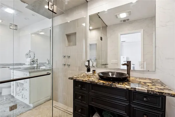 a dining hall with stainless steel appliances granite countertop a stove and cabinets