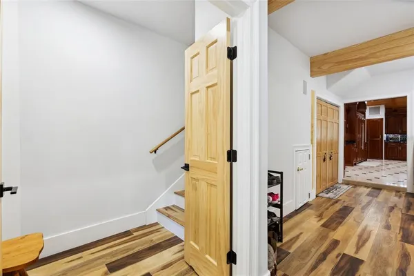 a view of a room with wooden floor and staircase