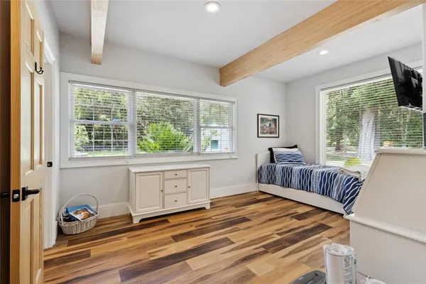 a kitchen with cabinets and wooden floor
