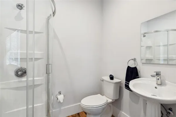 a bedroom with a bed and a flat tv screen on a dresser
