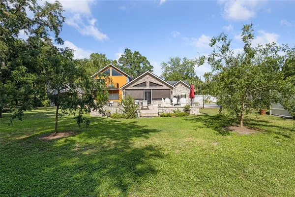 an aerial view of a house with a yard