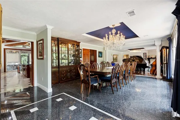 a living room with furniture floor to ceiling window and an outdoor view