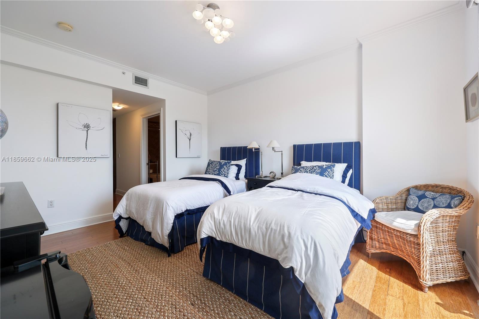 110 Hendricks Isle, Unit 13 Fort Lauderdale, FL 33301 - Photo 28 of 80 a bedroom with two beds and a lamp