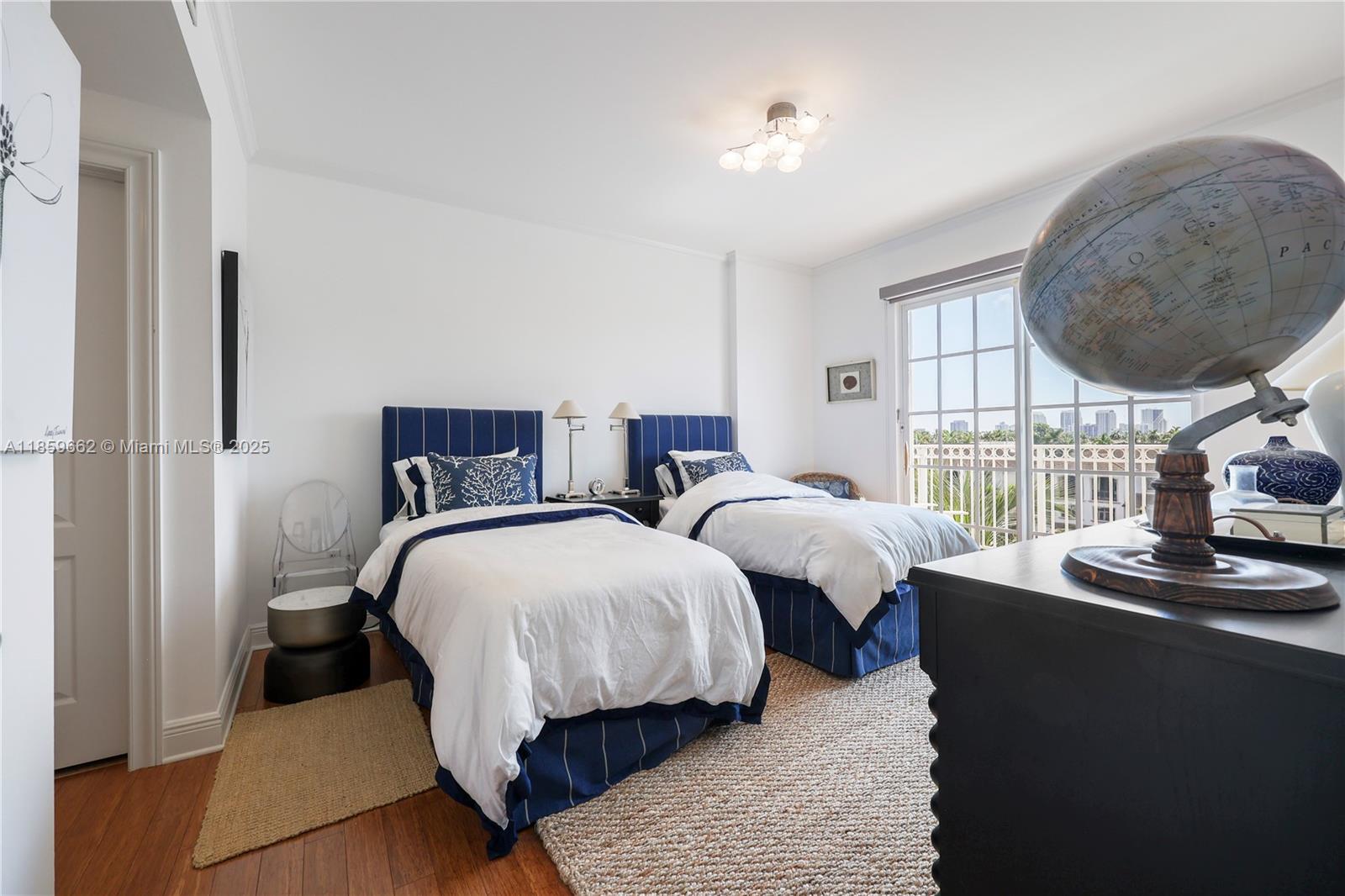 110 Hendricks Isle, Unit 13 Fort Lauderdale, FL 33301 - Photo 30 of 80 a bedroom with two beds and a large mirror next to a window