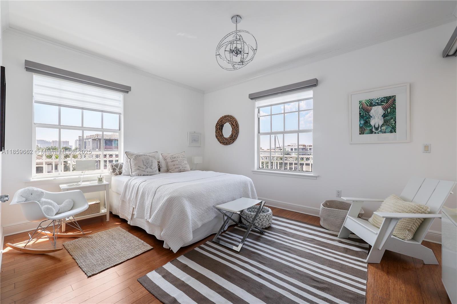 110 Hendricks Isle, Unit 13 Fort Lauderdale, FL 33301 - Photo 35 of 80 a bedroom with a bed and wooden floor