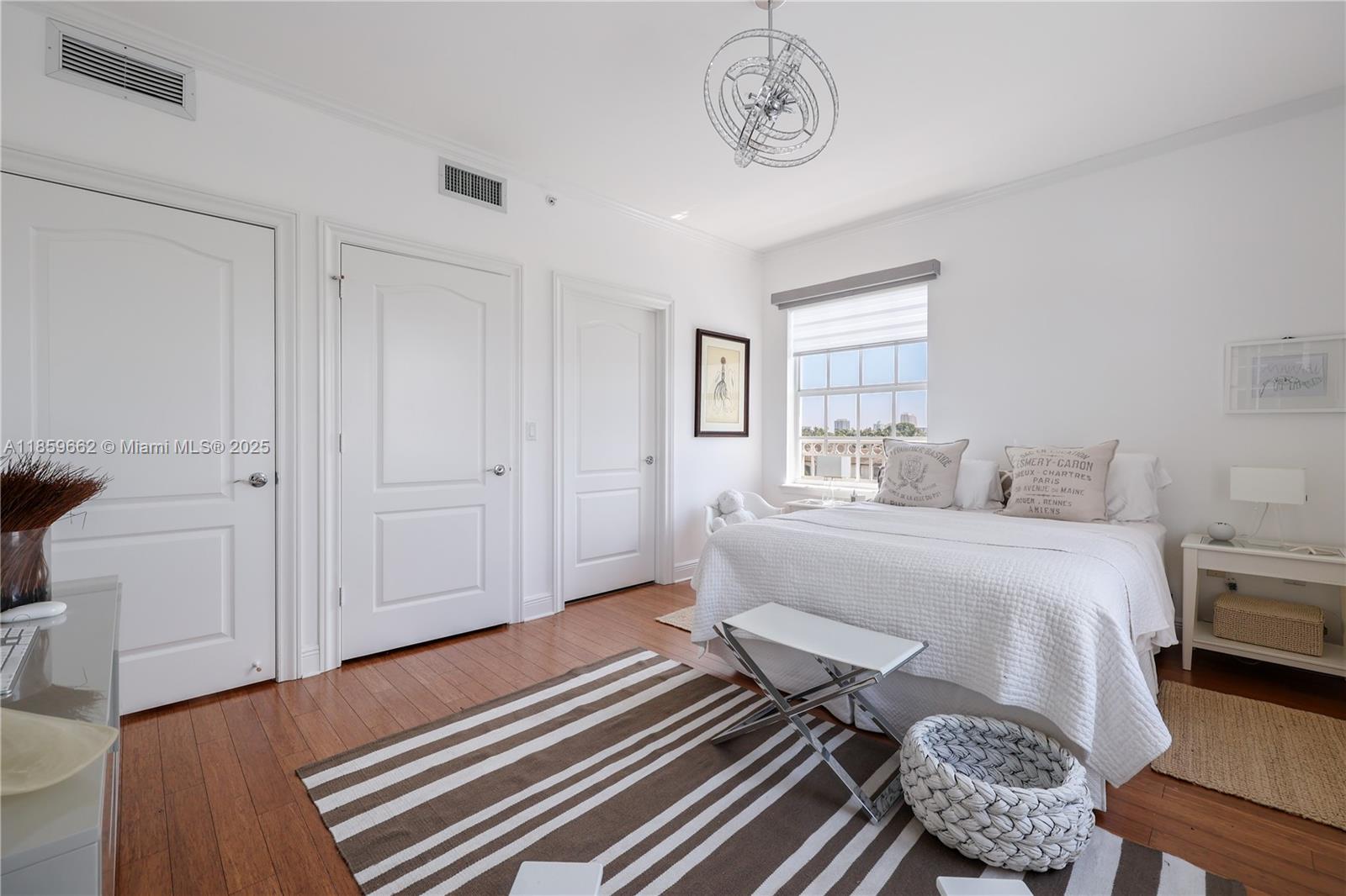 110 Hendricks Isle, Unit 13 Fort Lauderdale, FL 33301 - Photo 37 of 80 a bedroom with a bed and wooden floor