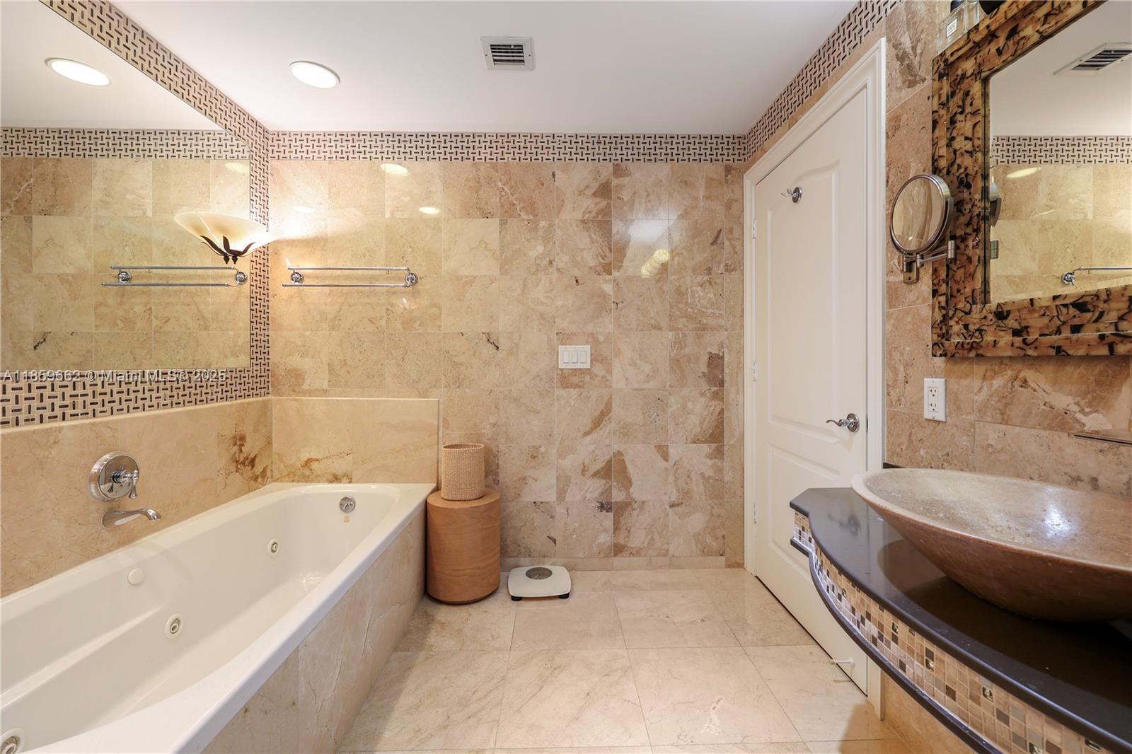 110 Hendricks Isle, Unit 13 Fort Lauderdale, FL 33301 - Photo 45 of 80 a bathroom with a tub a sink and a shower