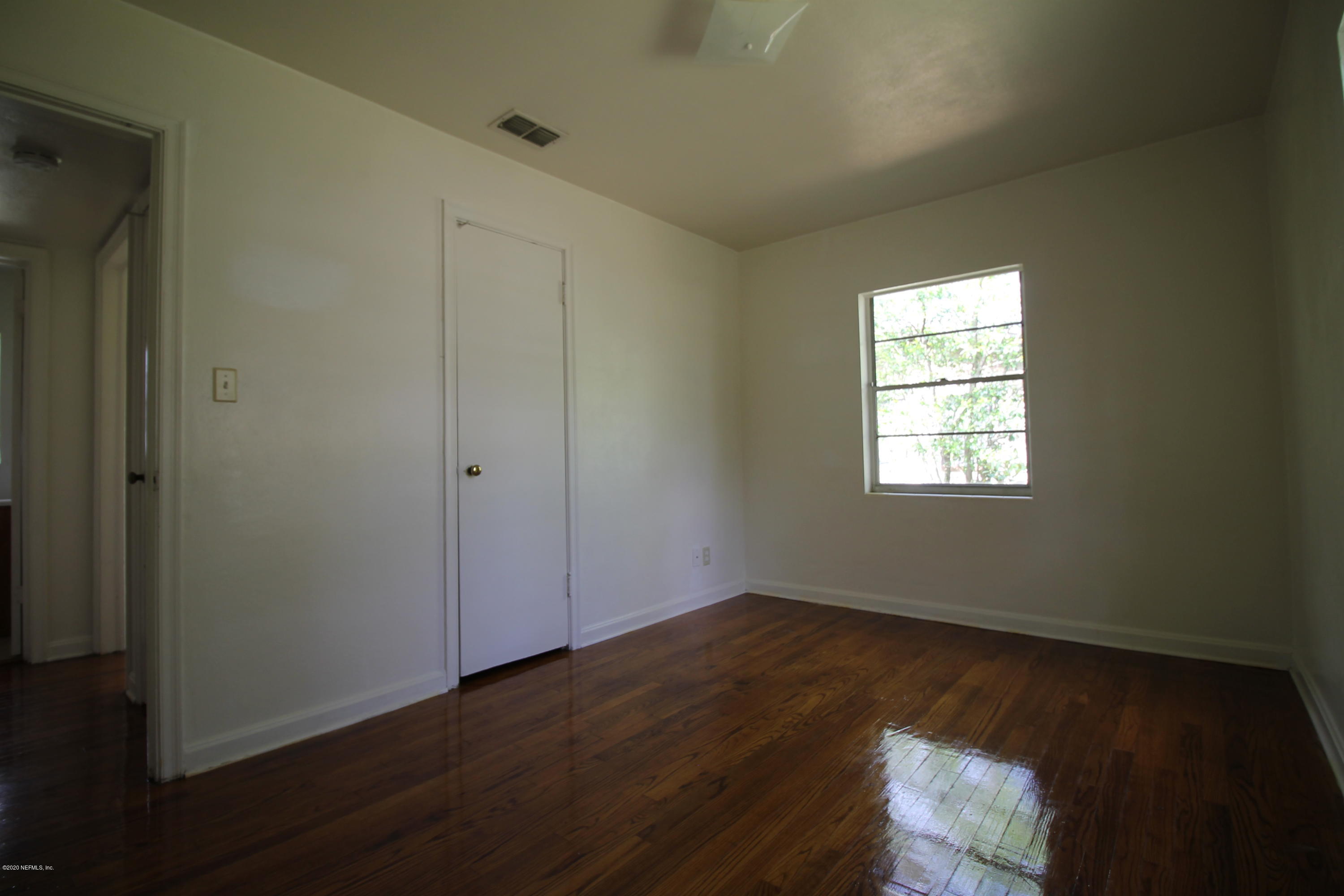 1728 Layton Road Jacksonville, FL 32211 - Photo 13 of 20 an empty room with wooden floor closet and windows
