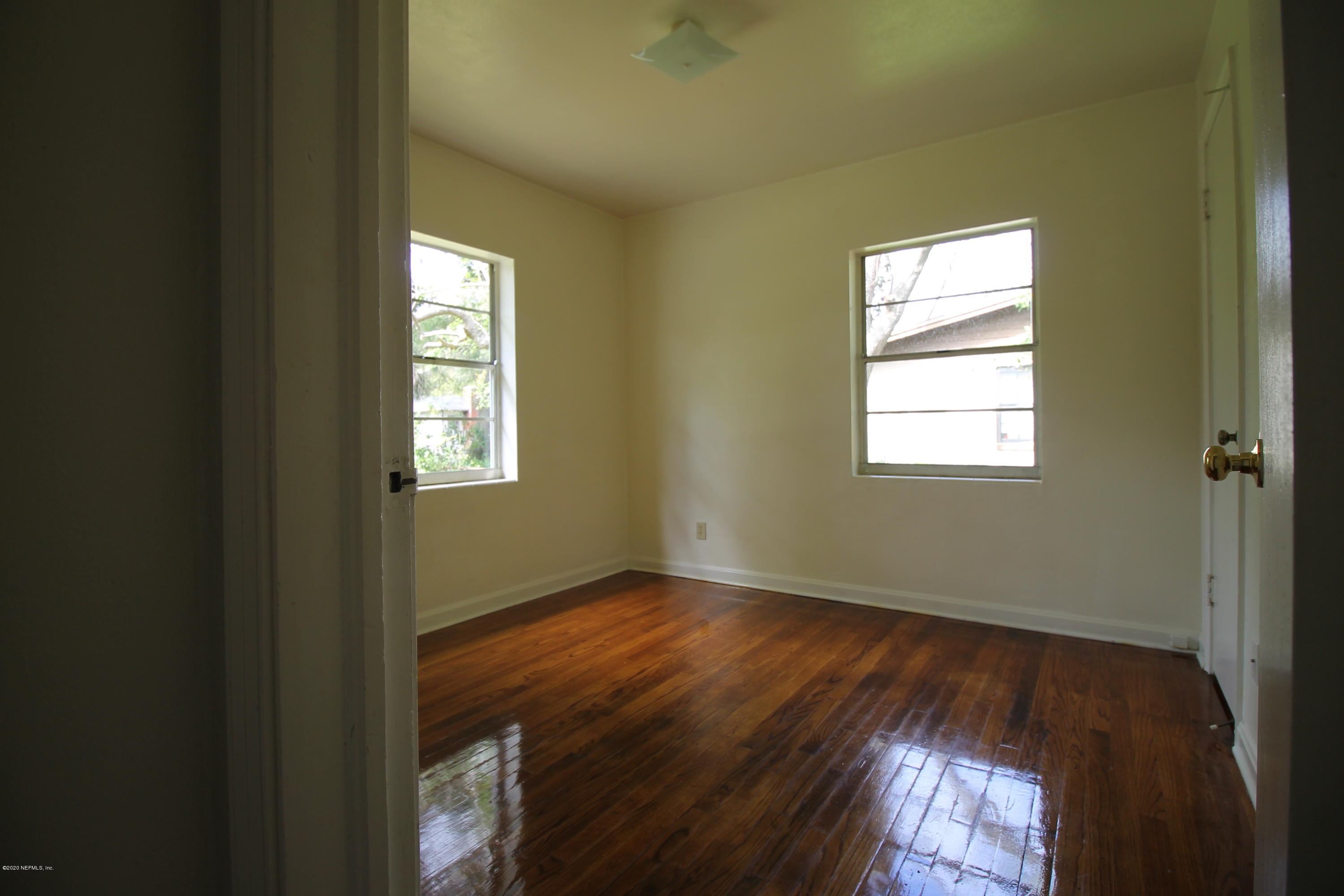 1728 Layton Road Jacksonville, FL 32211 - Photo 14 of 20 a view of an empty room with wooden floor and a window