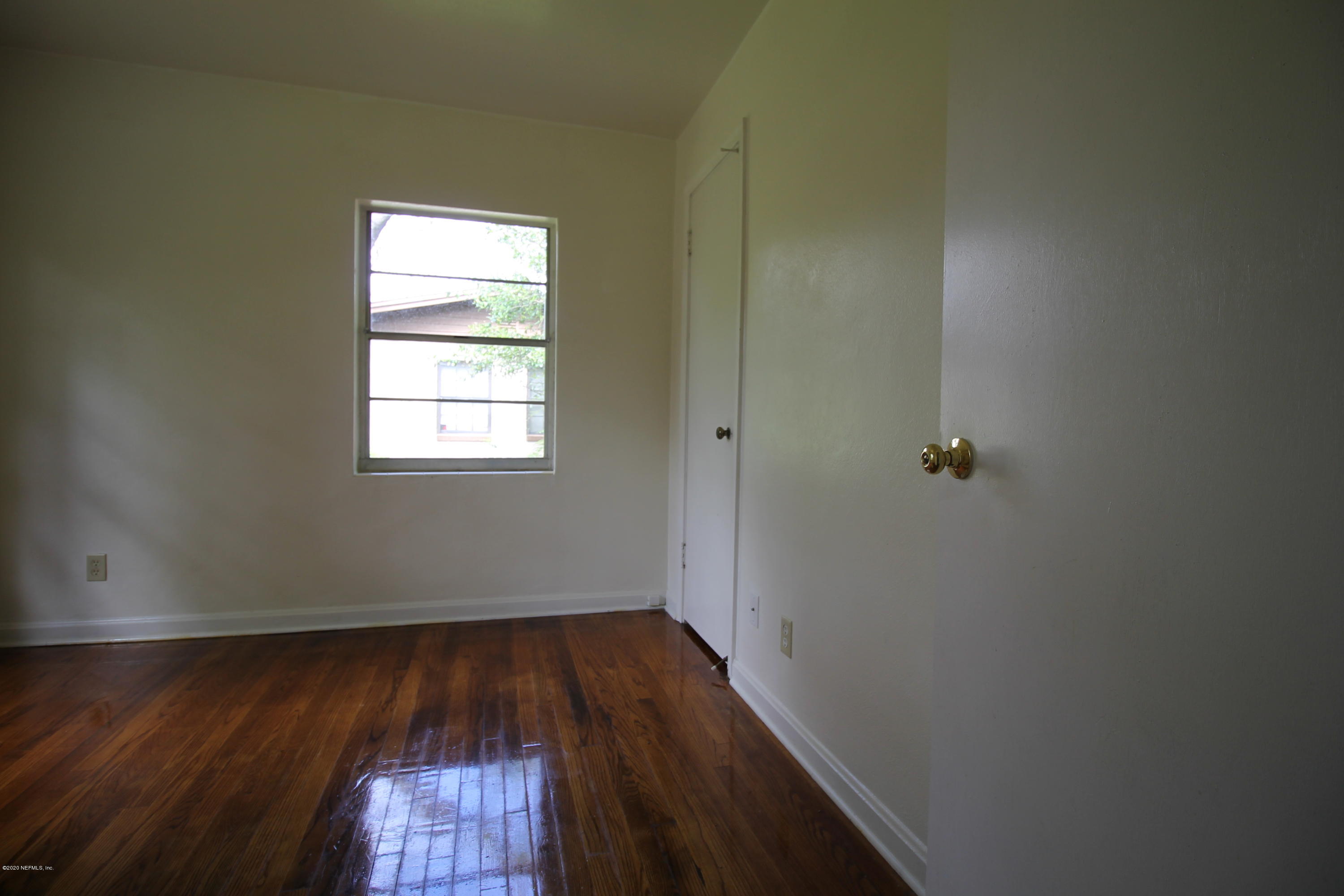 1728 Layton Road Jacksonville, FL 32211 - Photo 15 of 20 an empty room with wooden floor and windows
