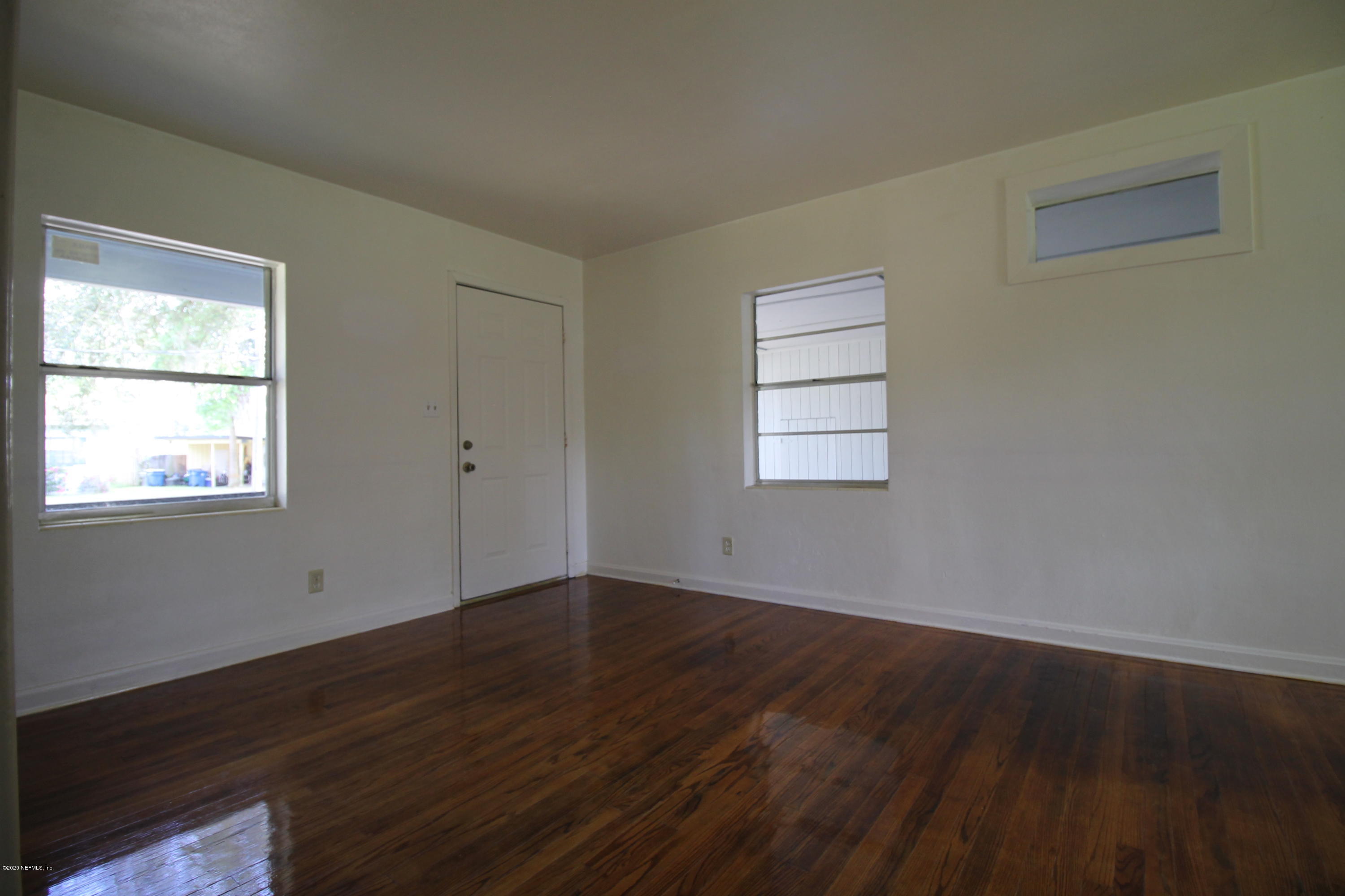 1728 Layton Road Jacksonville, FL 32211 - Photo 2 of 20 a view of an empty room with wooden floor and a window