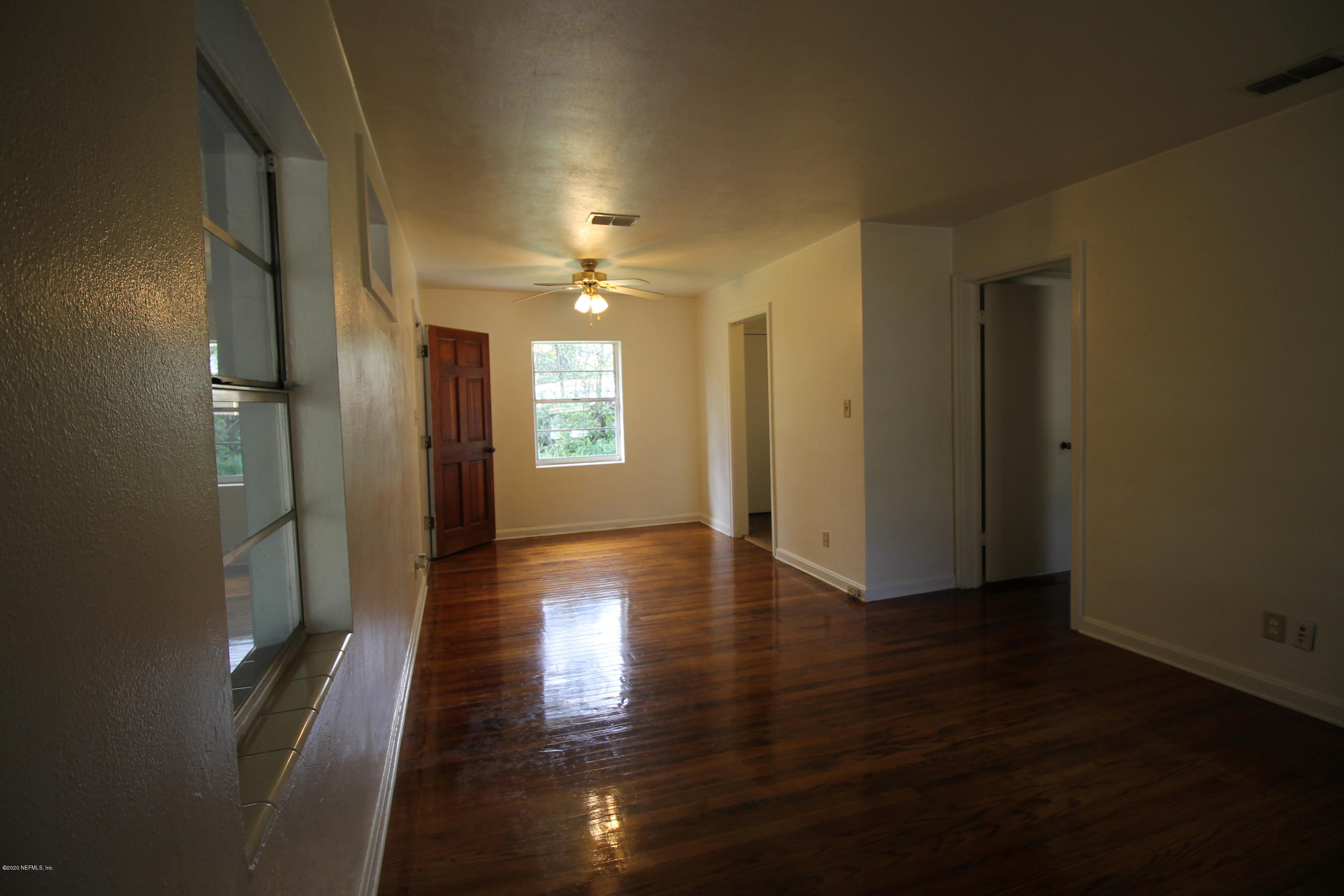 1728 Layton Road Jacksonville, FL 32211 - Photo 3 of 20 an empty room with wooden floor and windows