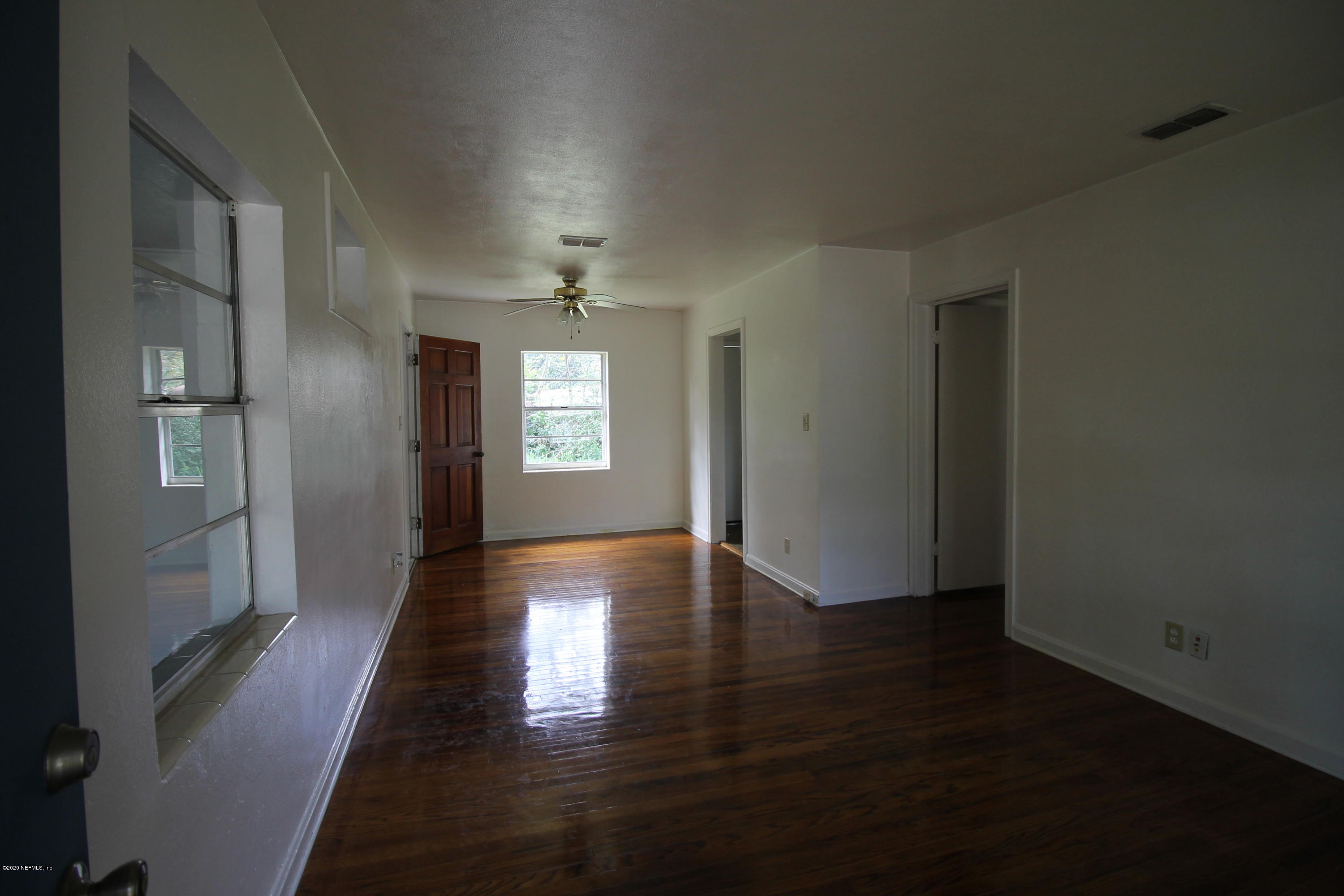 1728 Layton Road Jacksonville, FL 32211 - Photo 4 of 20 an empty room with wooden floor and windows