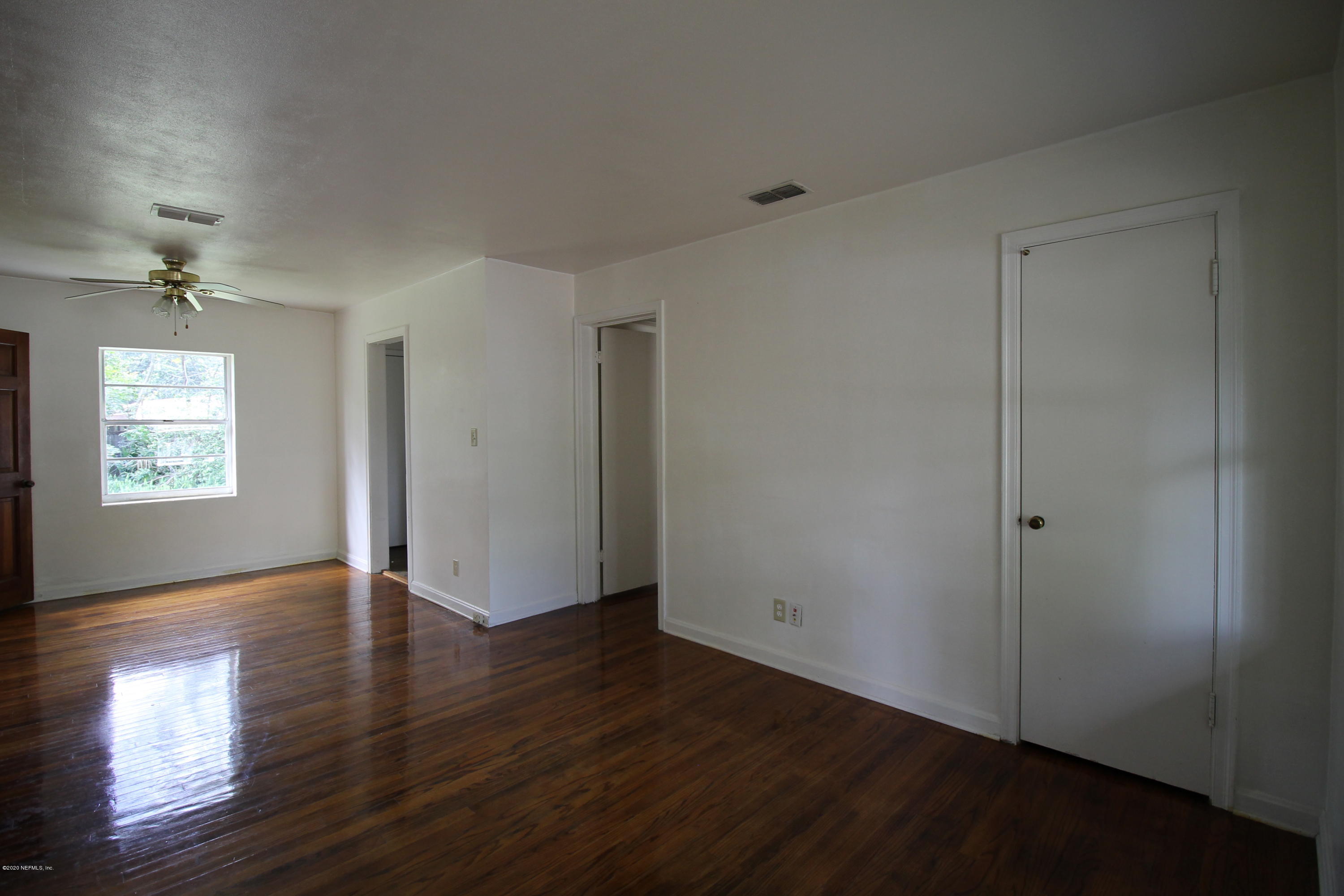 1728 Layton Road Jacksonville, FL 32211 - Photo 5 of 20 an empty room with wooden floor and windows