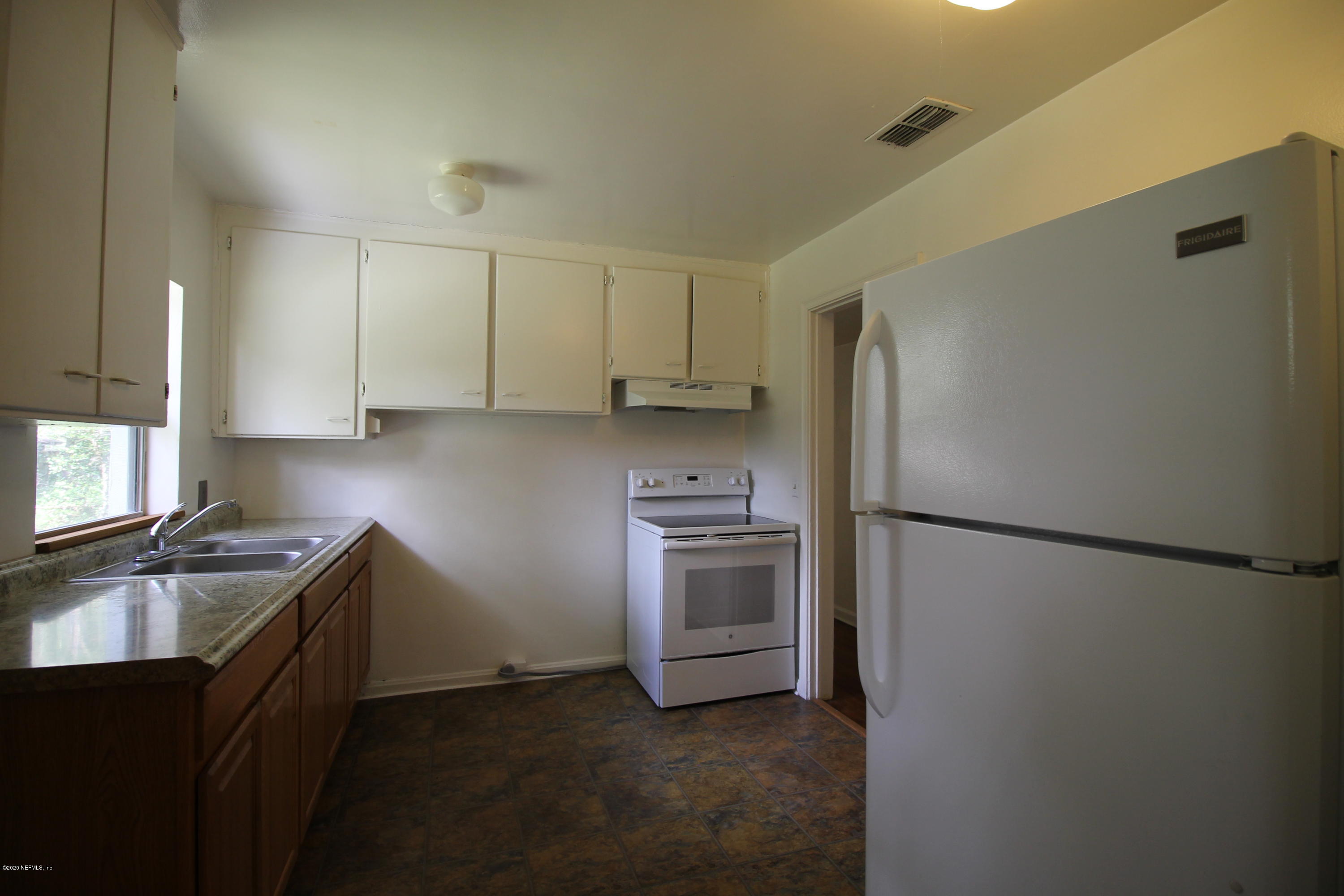 1728 Layton Road Jacksonville, FL 32211 - Photo 6 of 20 a kitchen with a refrigerator sink and stove
