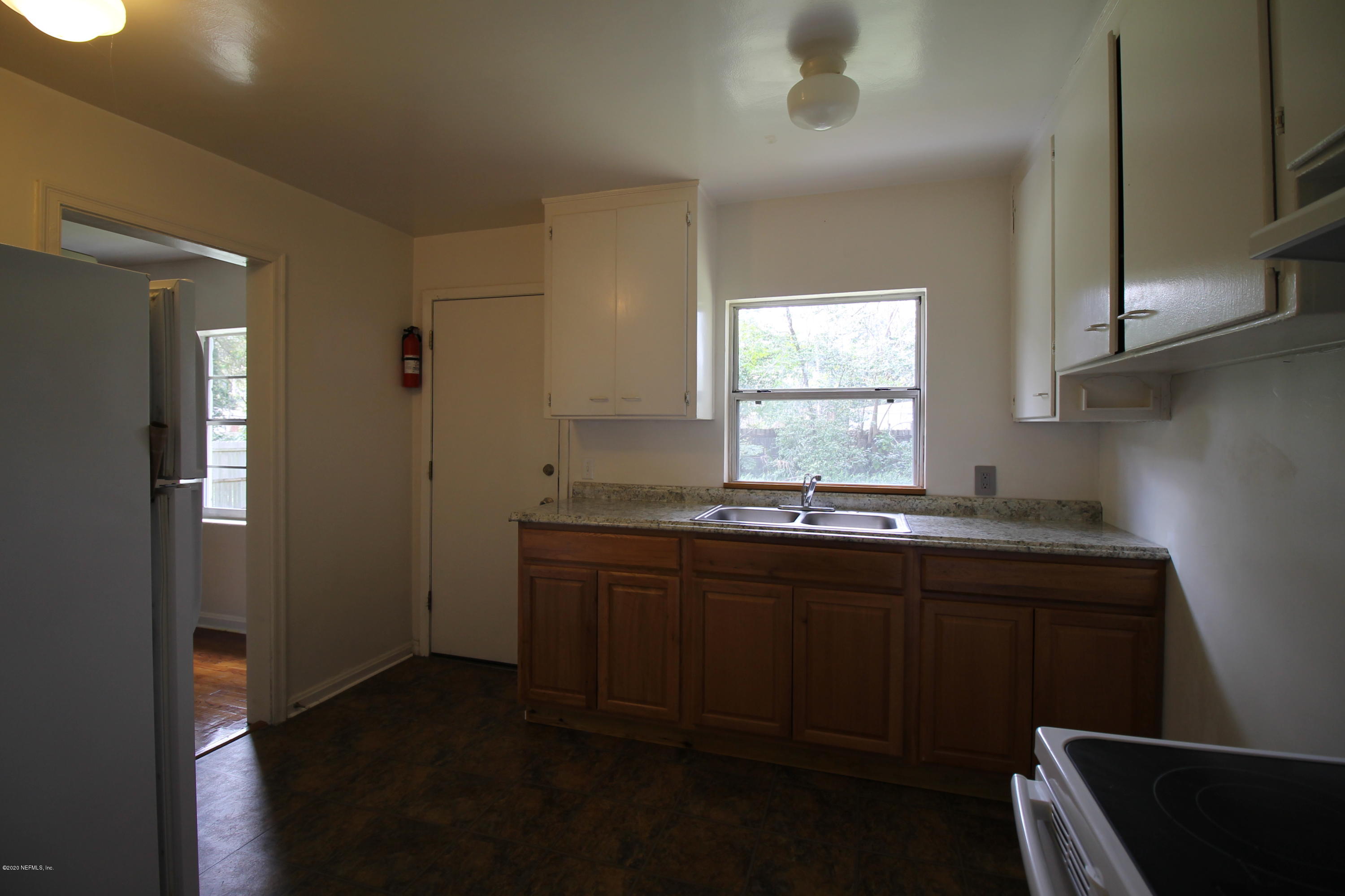 1728 Layton Road Jacksonville, FL 32211 - Photo 7 of 20 a kitchen with sink window and cabinets