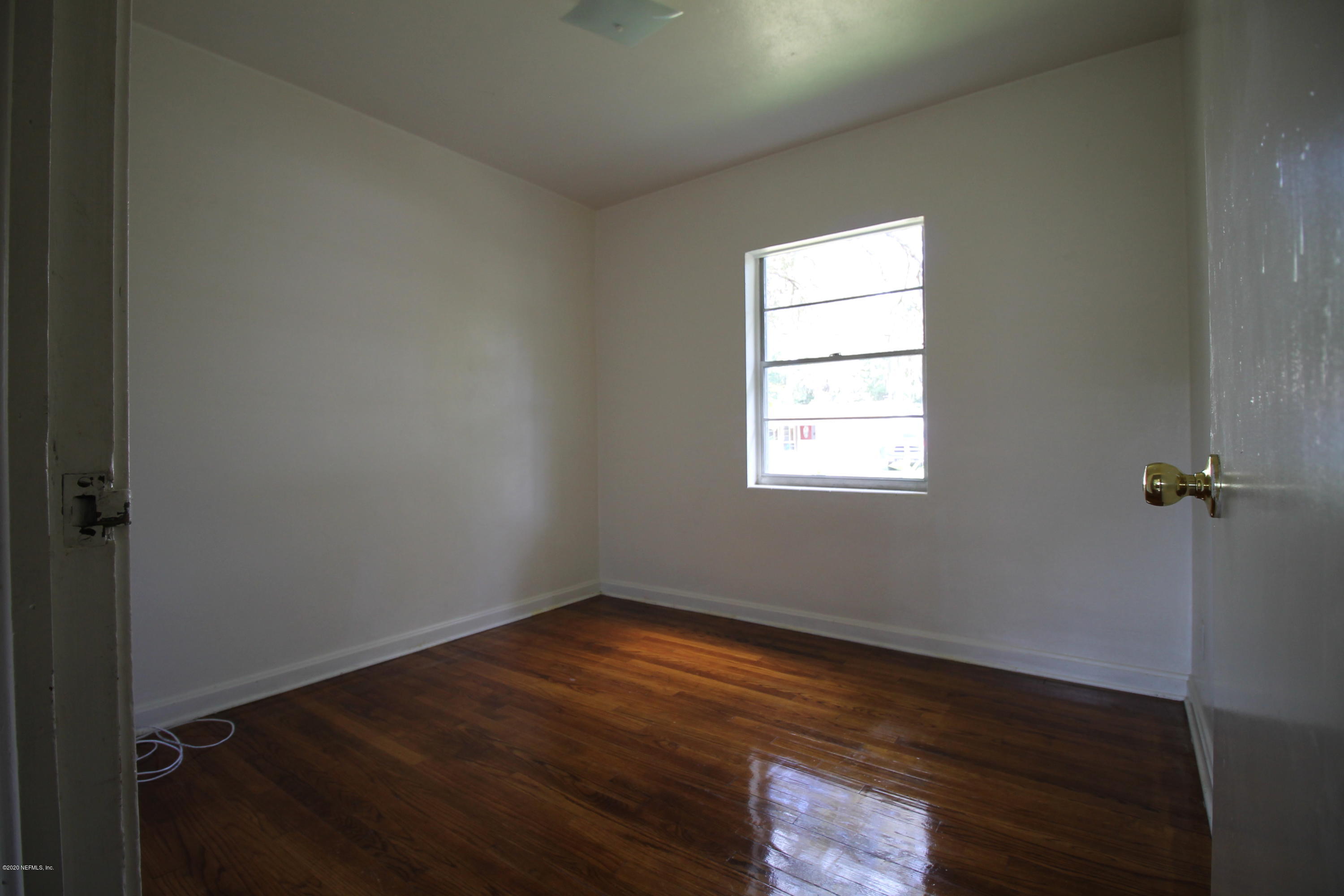 1728 Layton Road Jacksonville, FL 32211 - Photo 10 of 20 an empty room with wooden floor and windows