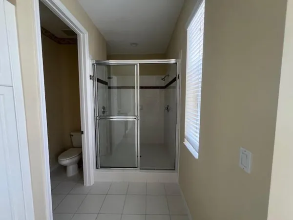a bathroom with a glass shower door and a sink