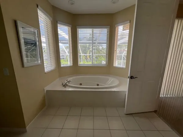 a bathroom with a bathtub and window