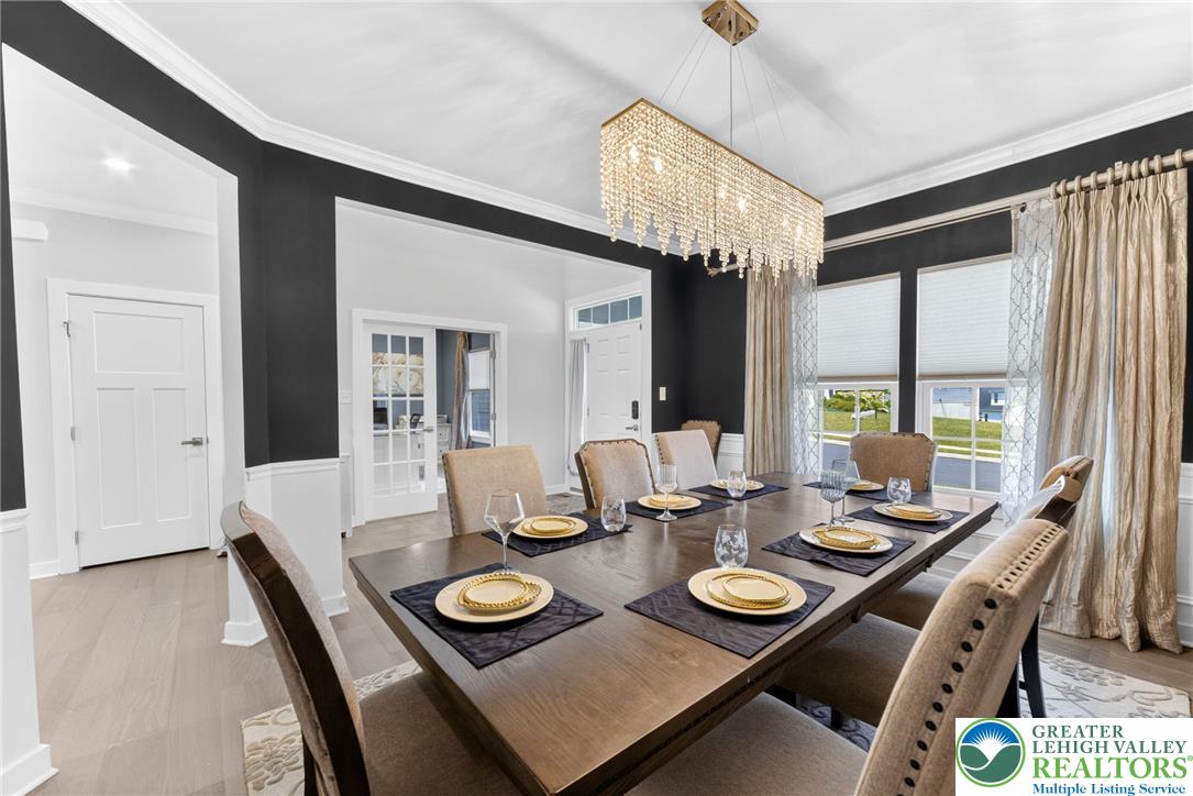 3952 Orth Street Bethlehem, PA 18020 - Photo 8 of 60 A radiant chandelier illuminates this dining area with abundant natural light from wide windows.