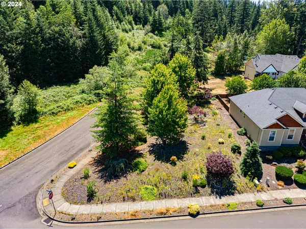 an aerial view of a house with a yard lake and outdoor seating
