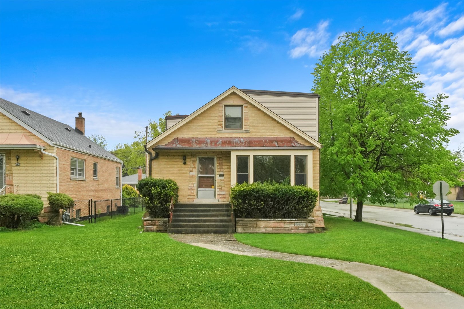 a front view of a house with a garden