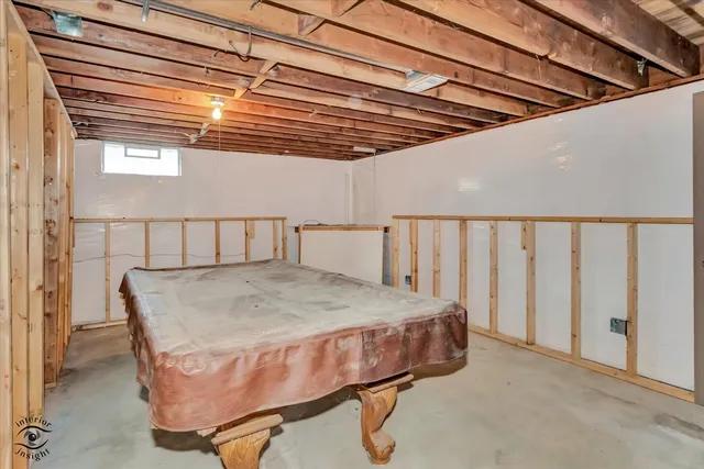 a bed sitting in a room next to a window