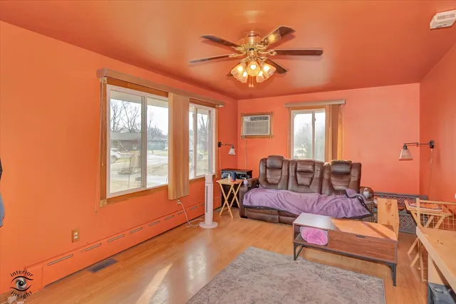 a living room with furniture and chandelier