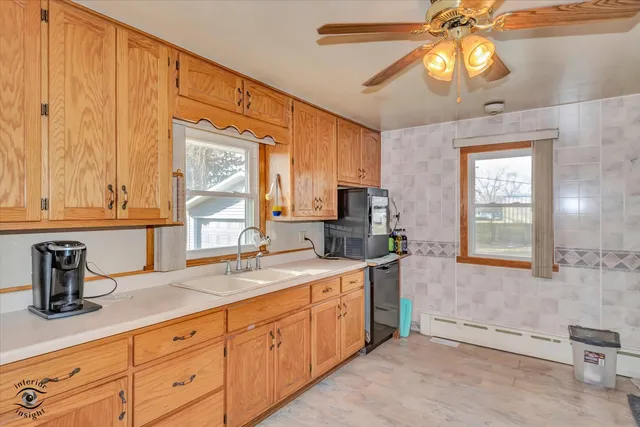 a kitchen with a sink cabinets and window