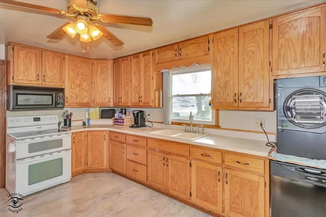 a kitchen with granite countertop white cabinets and stainless steel appliances