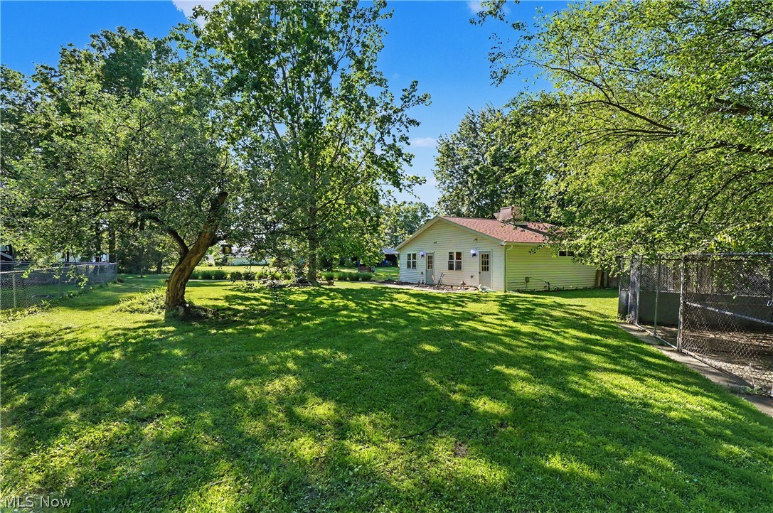 4250 Herr Fieldhouse Road Southington, OH 44470 - Photo 28 of 50 Expansive rear yard featuring mature trees and a manicured lawn