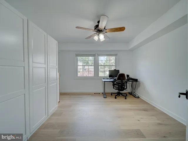 a view of an empty room with furniture and window