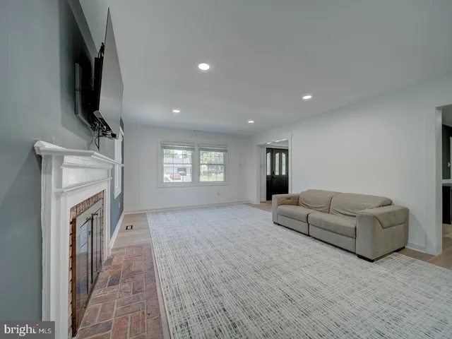 a front view of a house with a yard and potted plants