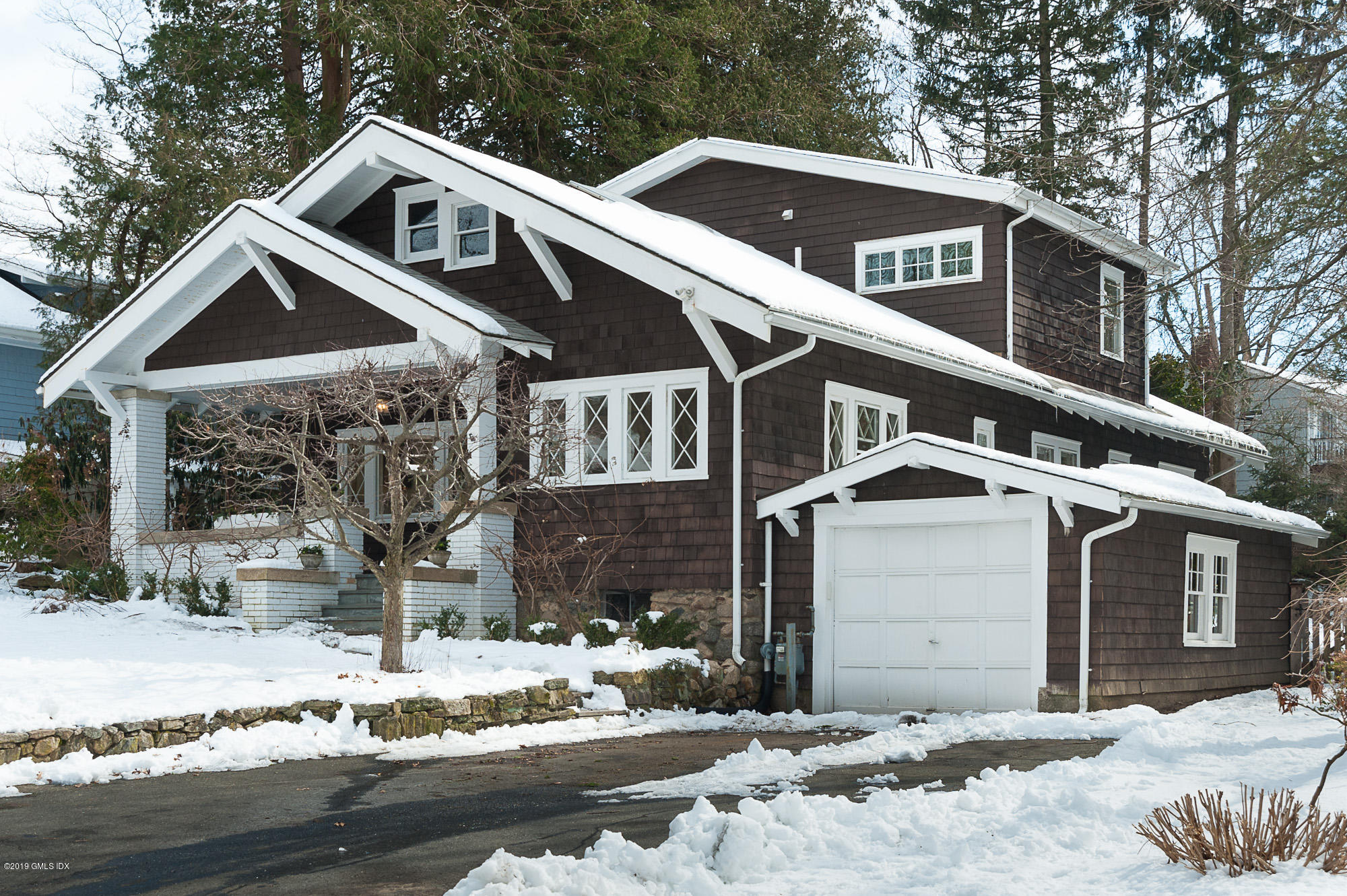 28 Chapel Lane Riverside, CT 06878 - Photo 2 of 38 a front view of a house with a yard