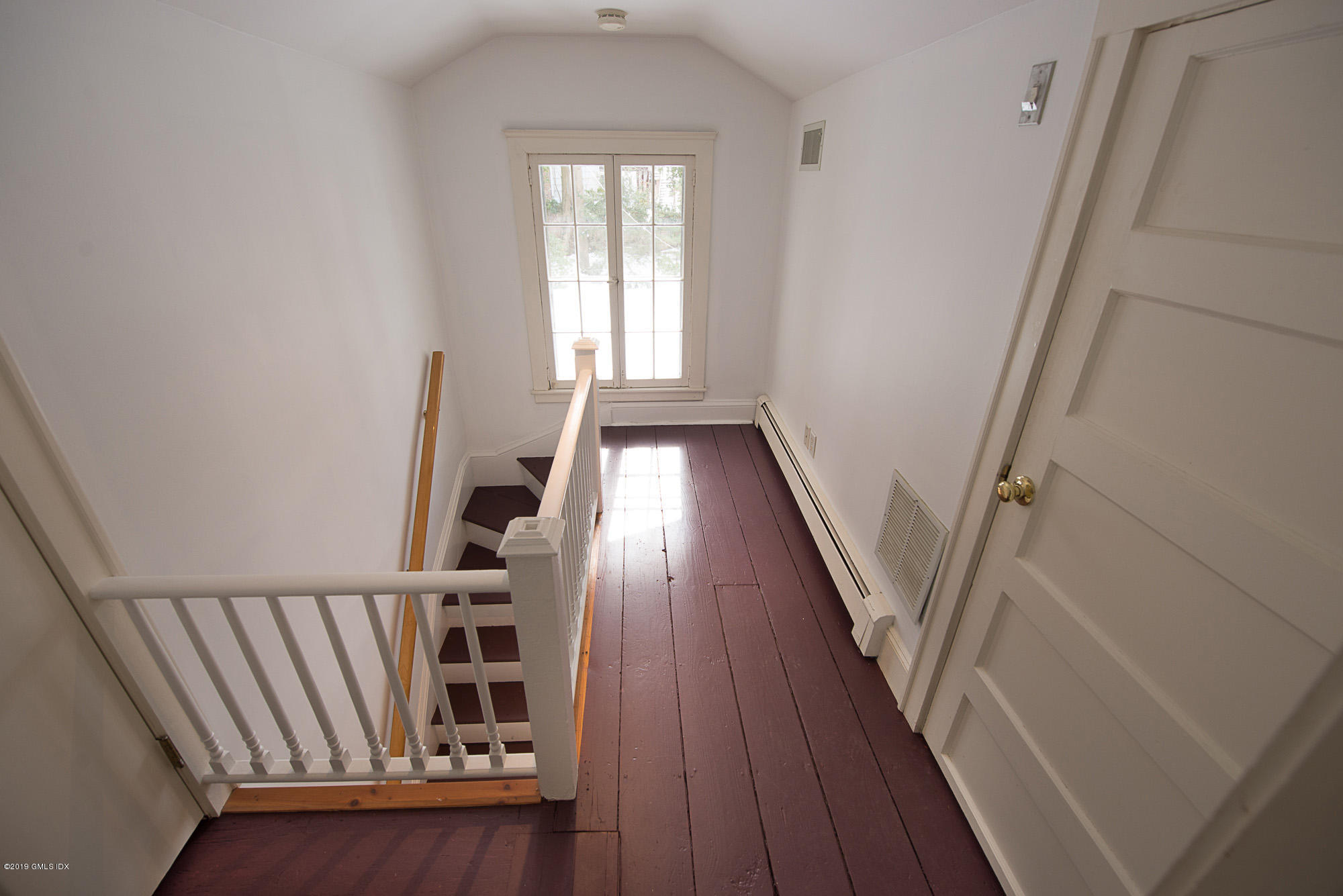 28 Chapel Lane Riverside, CT 06878 - Photo 24 of 38 a view of a hallway with wooden floor and staircase