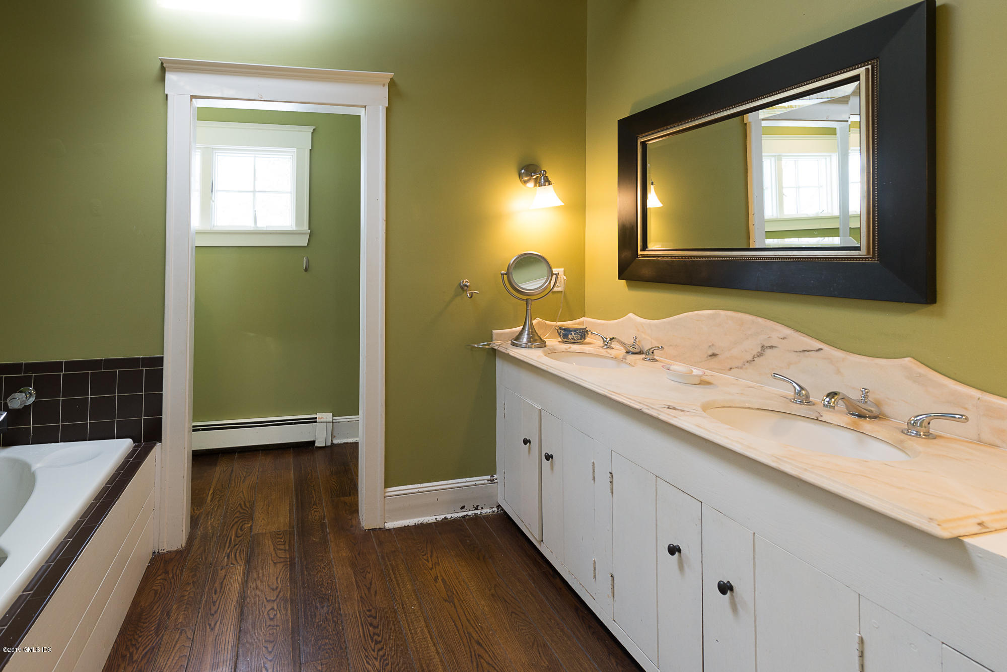 28 Chapel Lane Riverside, CT 06878 - Photo 25 of 38 a bathroom with a granite countertop sink a mirror and a bathtub