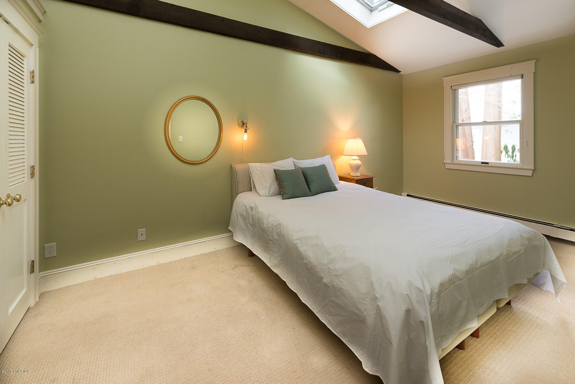 28 Chapel Lane Riverside, CT 06878 - Photo 28 of 38 a bed room with a bed mirror and a window