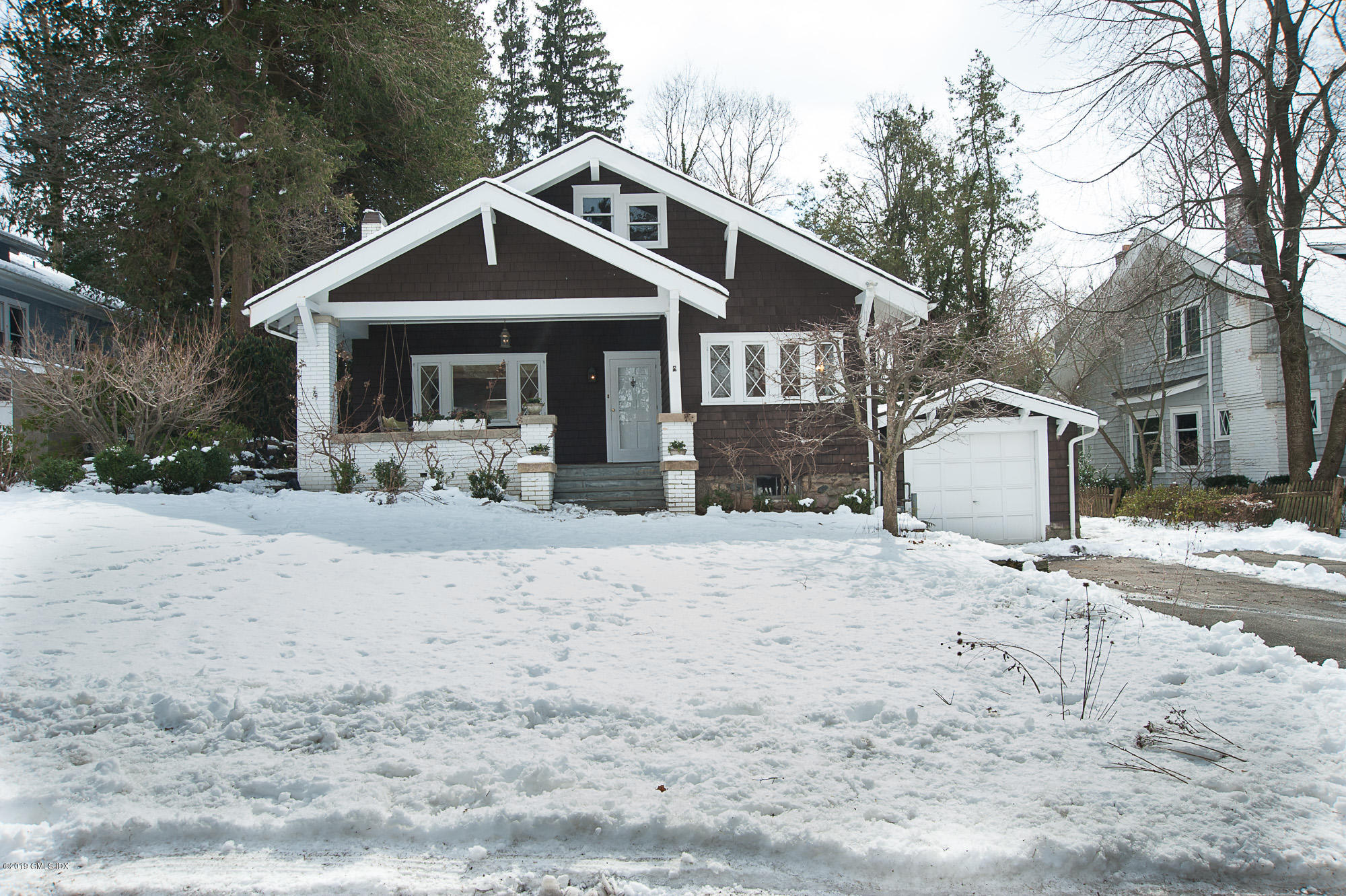 28 Chapel Lane Riverside, CT 06878 - Photo 34 of 38 a front view of a house with a yard covered in snow