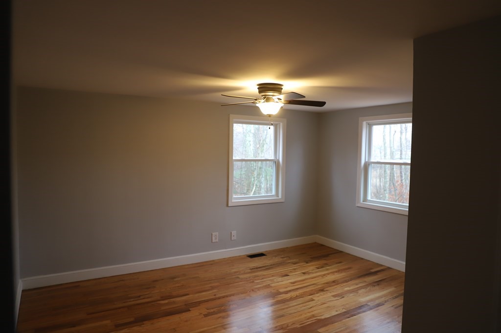 5 Hunt Road North Brookfield, MA 01535 - Photo 13 of 26 a view of an empty room with wooden floor and a window