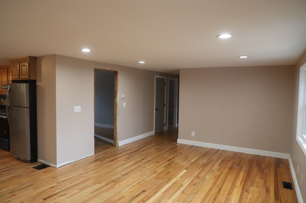 5 Hunt Road North Brookfield, MA 01535 - Photo 7 of 26 a view of an empty room with wooden floor and a bathroom