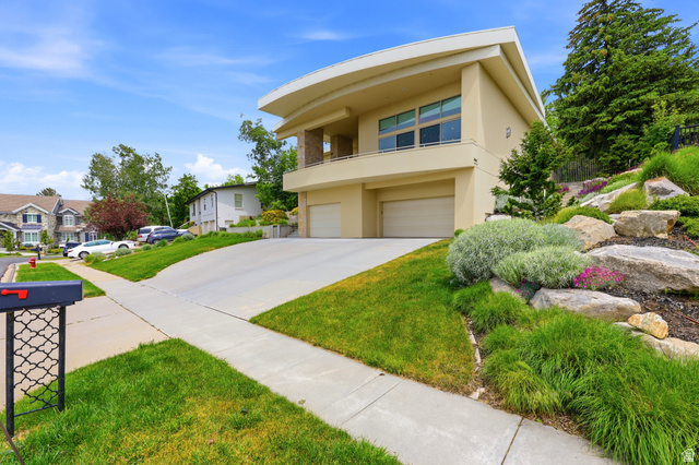 1389 Millbrook Way Bountiful, UT 84010 - Photo 7 of 74 Contemporary stucco exterior with a curved roofline and upper-level balcony