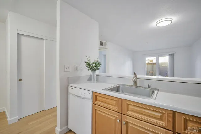 a kitchen with a stove top oven sink and cabinets