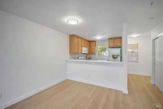 a view of a kitchen cabinets and a wooden floor