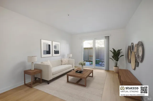 a living room with furniture a window and a table