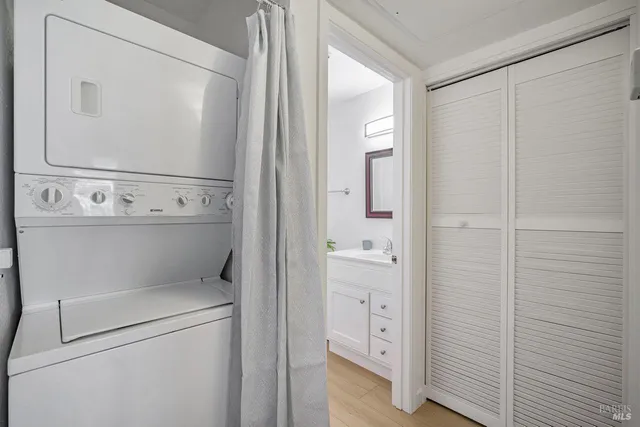 a bathroom with a sink a toilet a mirror and shower