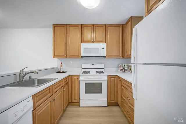 a kitchen with stainless steel appliances granite countertop a refrigerator sink and cabinets