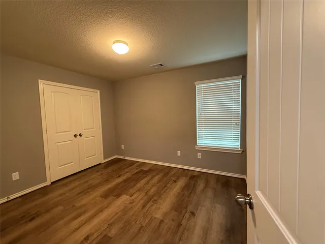 a bathroom with a granite countertop sink a mirror and a bathtub