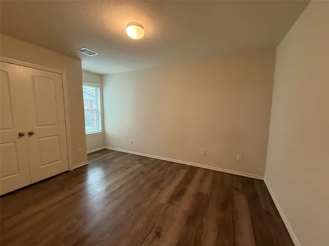 a view of a room with wooden floor