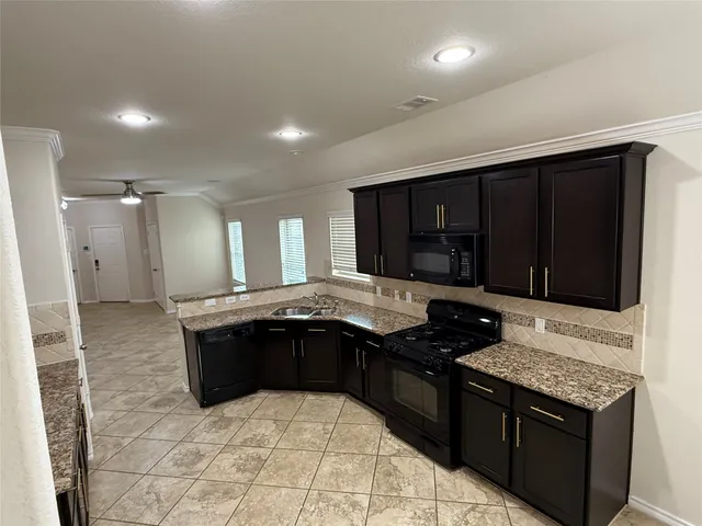 a bathroom with a granite countertop sink a mirror and a bathtub